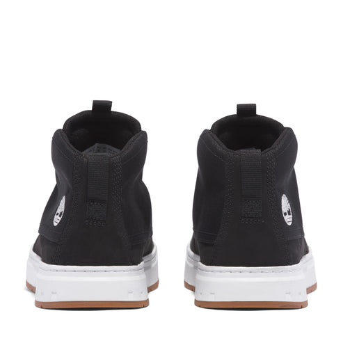Rear view of black high top sneakers with white soles.