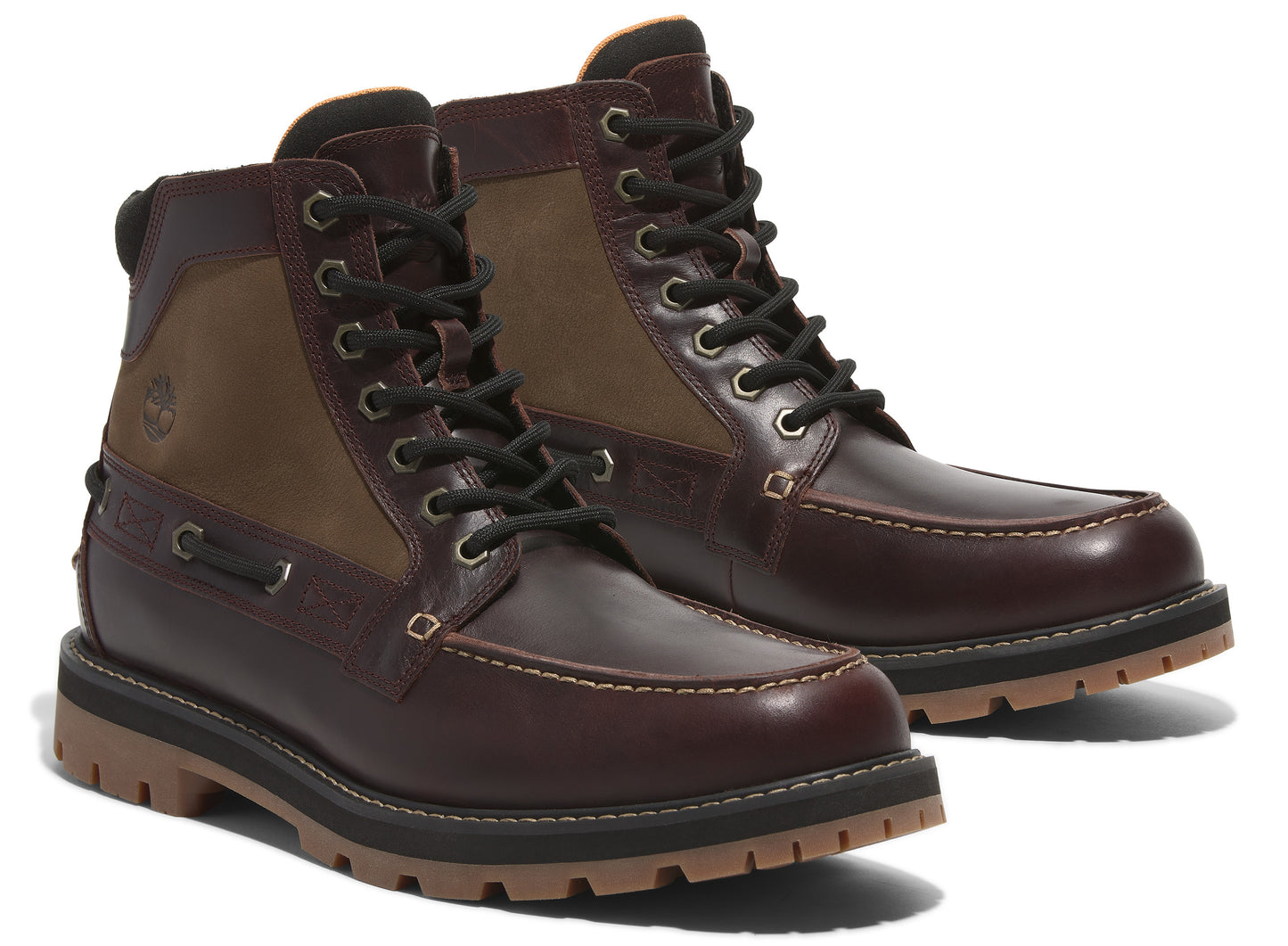 Pair of leather ankle boots in brown and tan with black laces and lug soles.