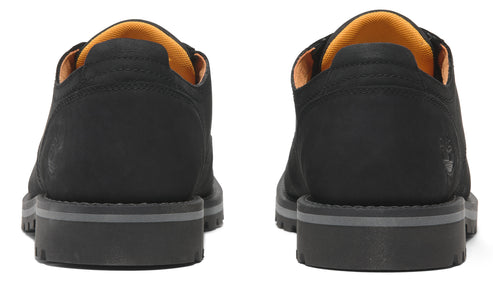 Back view of a pair of black leather derby shoes with orange linings and grey soles.