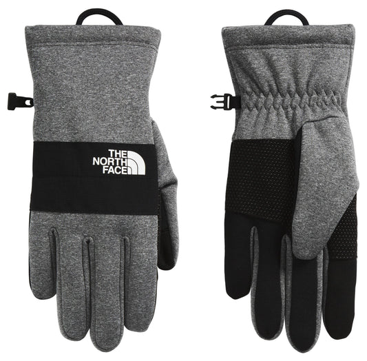 Pair of gray fleece gloves with a black band, THE NORTH FACE logo, black fingertips and adjustable wrist buckle.