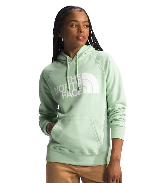 A woman wearing a light green hoodie with the words "THE NORTH FACE" printed in large white letters across the chest.