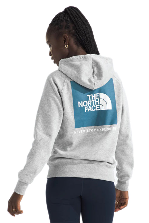 Person wearing a gray hooded sweatshirt with logo of "THE NORTH FACE NEVER STOP EXPLORING" on the back.