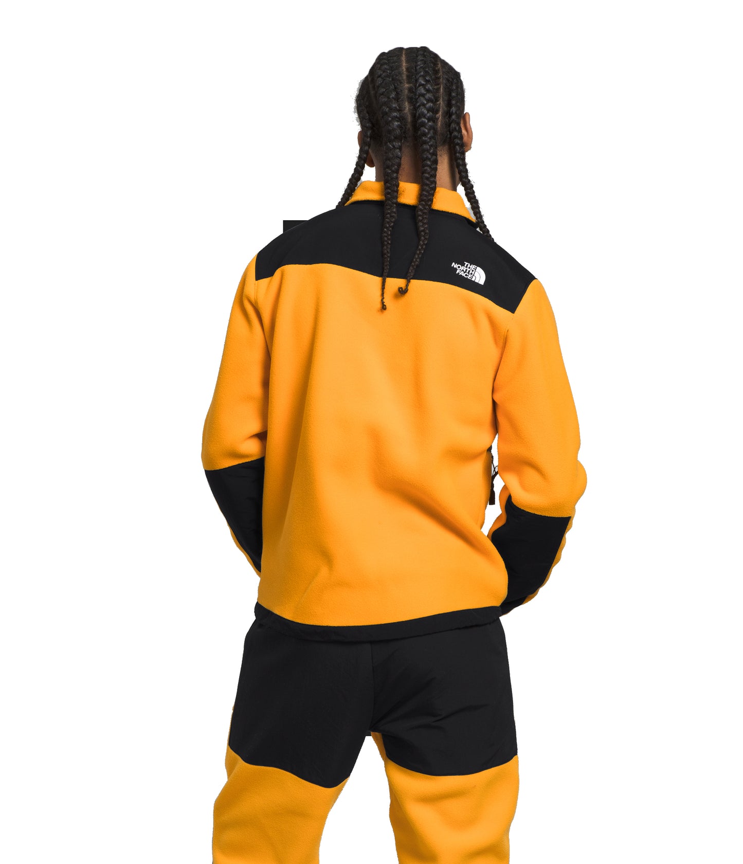 Person wearing a gold and black jacket with a logo on the upper left shoulder.