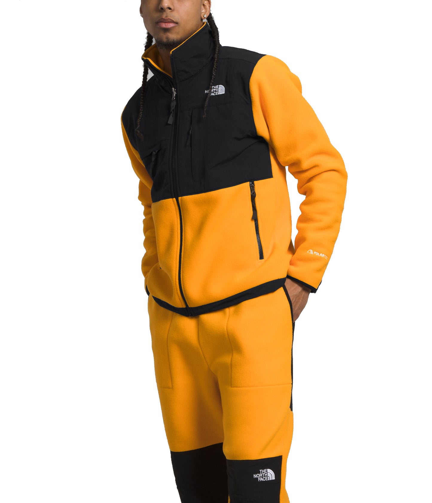 A person wearing a yellow and black fleece jacket with matching pants.