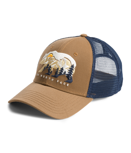 Khaki and navy blue trucker cap with a bear, mountain, and tree graphic on the front.