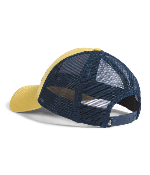 Rear view of a two-tone corduroy trucker hat with navy blue mesh.