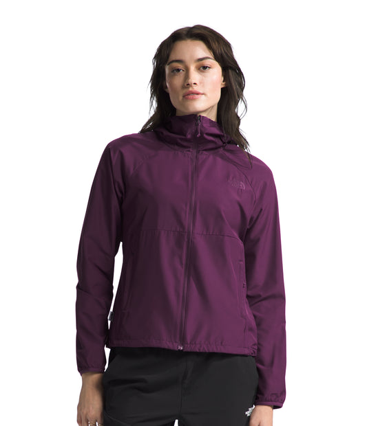 A woman wearing a long-sleeved, plum-colored hooded jacket with a zipper.