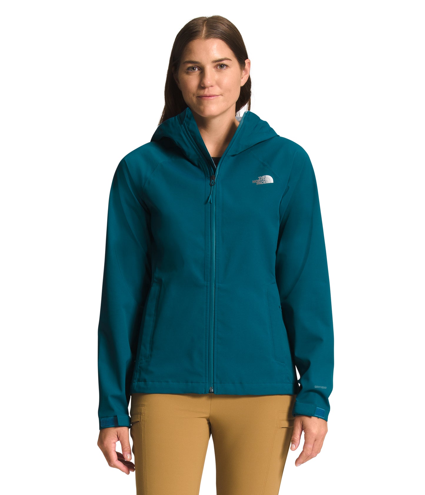 A woman wearing a teal hooded zip-up jacket and khaki pants.