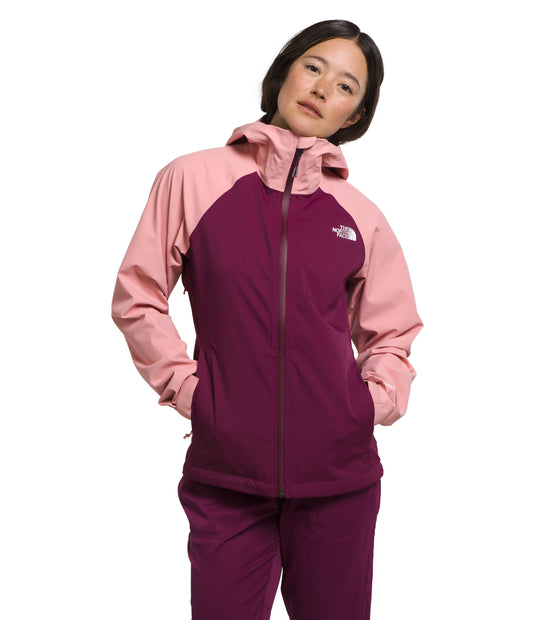 A woman is wearing a two-toned pink and purple hooded jacket with a zipper front.