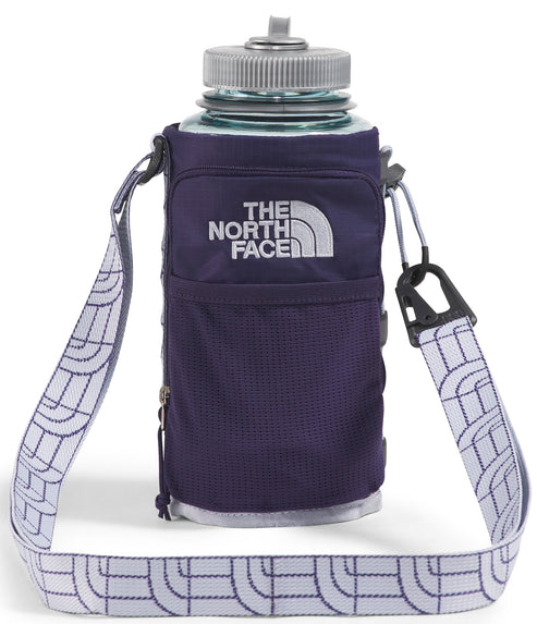 A water bottle in a purple holder with an attached white shoulder strap featuring a repeating North Face logo.