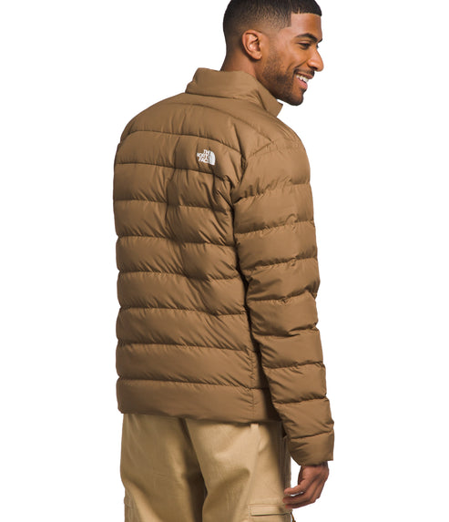 Man wearing a brown quilted puffer jacket.