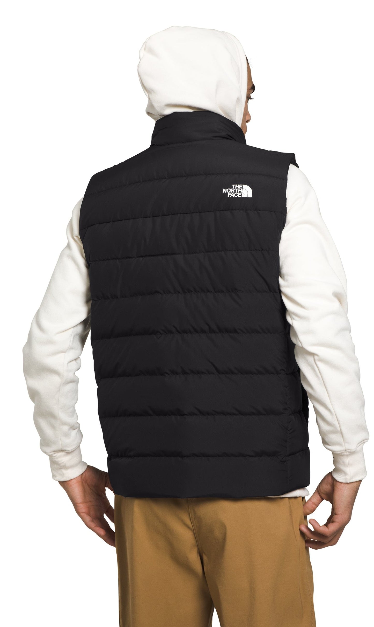 Black quilted vest with white logo.