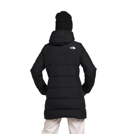 Rear view of black quilted parka with hood and matching beanie.