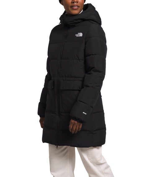 Person wearing a long black puffer jacket with a hood.