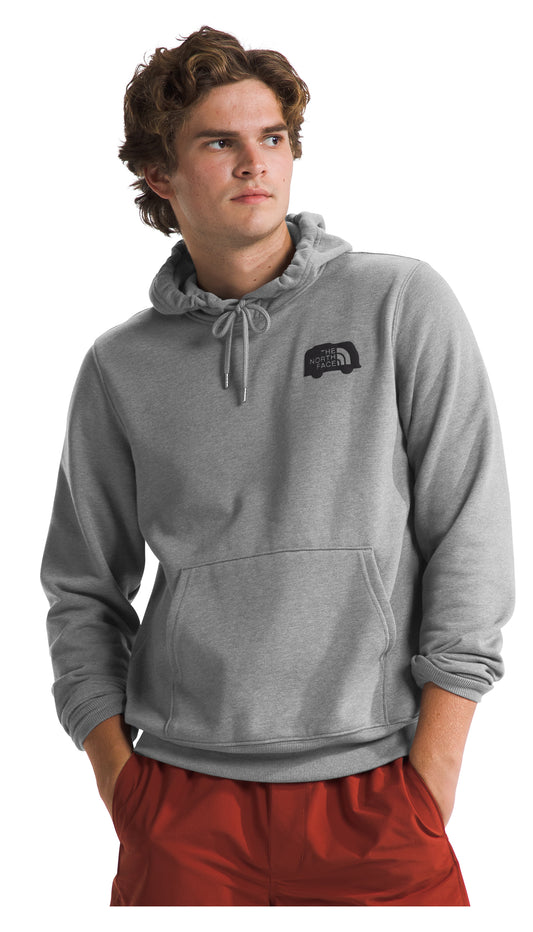 Man wearing a gray hoodie with a chest logo and a kangaroo pocket, paired with red pants.