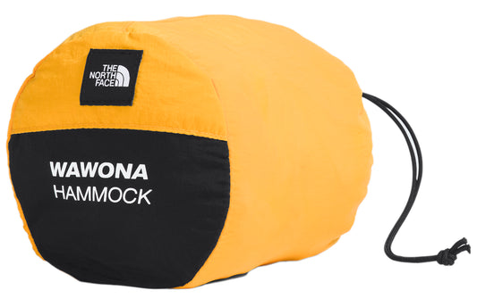 Yellow and black cylindrical carry bag with a black drawstring and white text: "WAWONA HAMMOCK", and a square logo with white text on a black background.