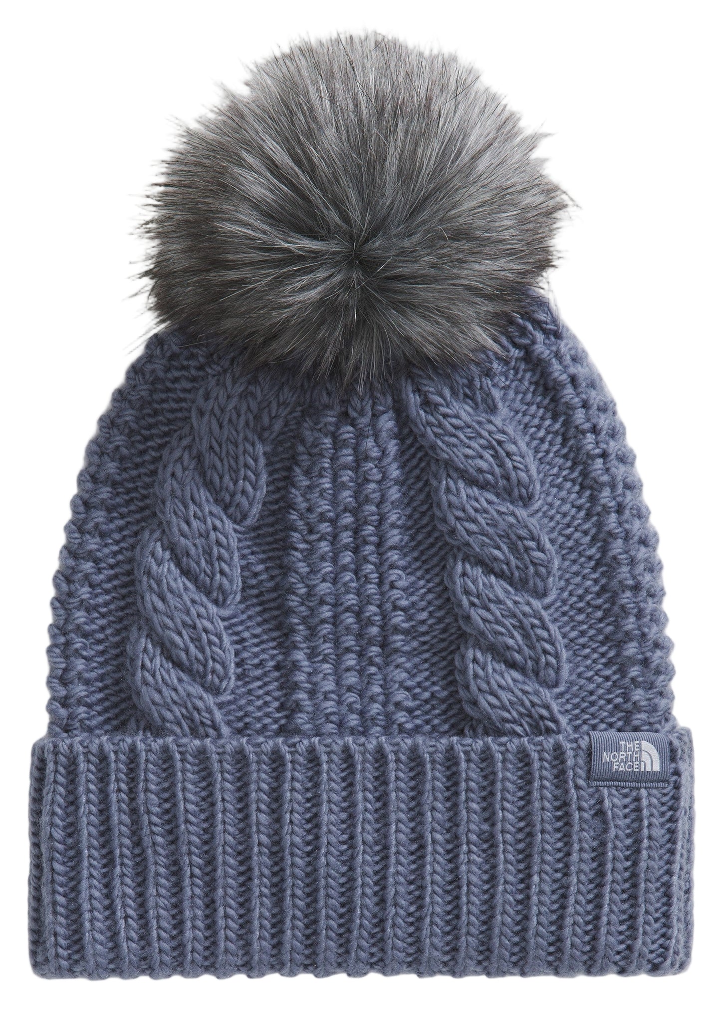Knit blue beanie with a grey faux fur pompom.