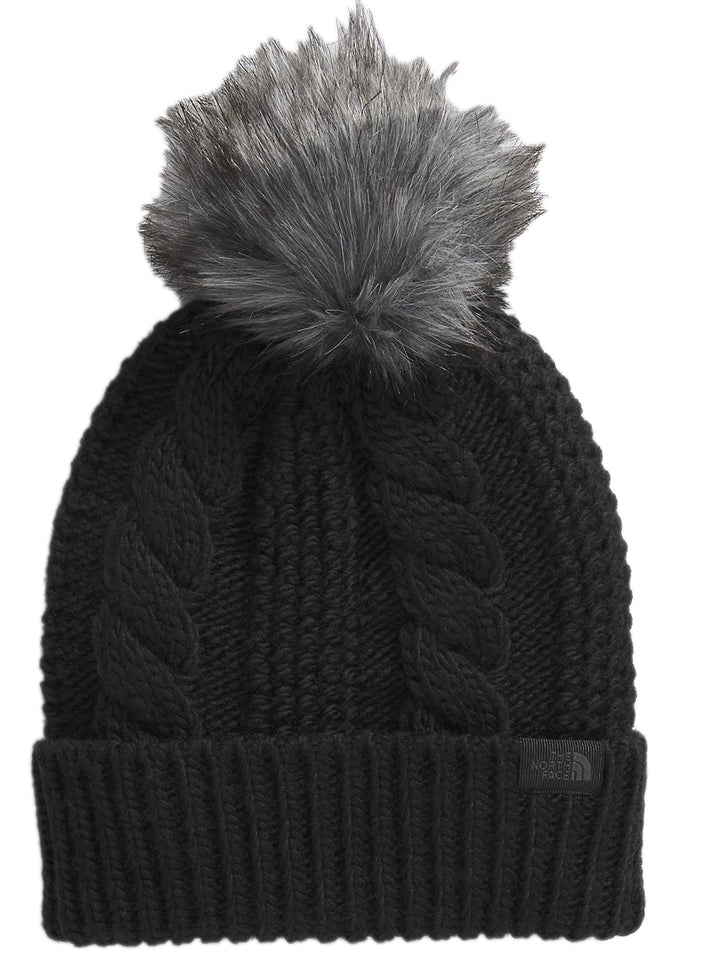 Black knit hat with cable pattern and faux fur pom.