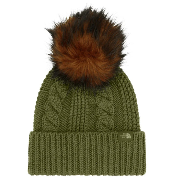 Green cable knit hat with a brown faux fur pompom.