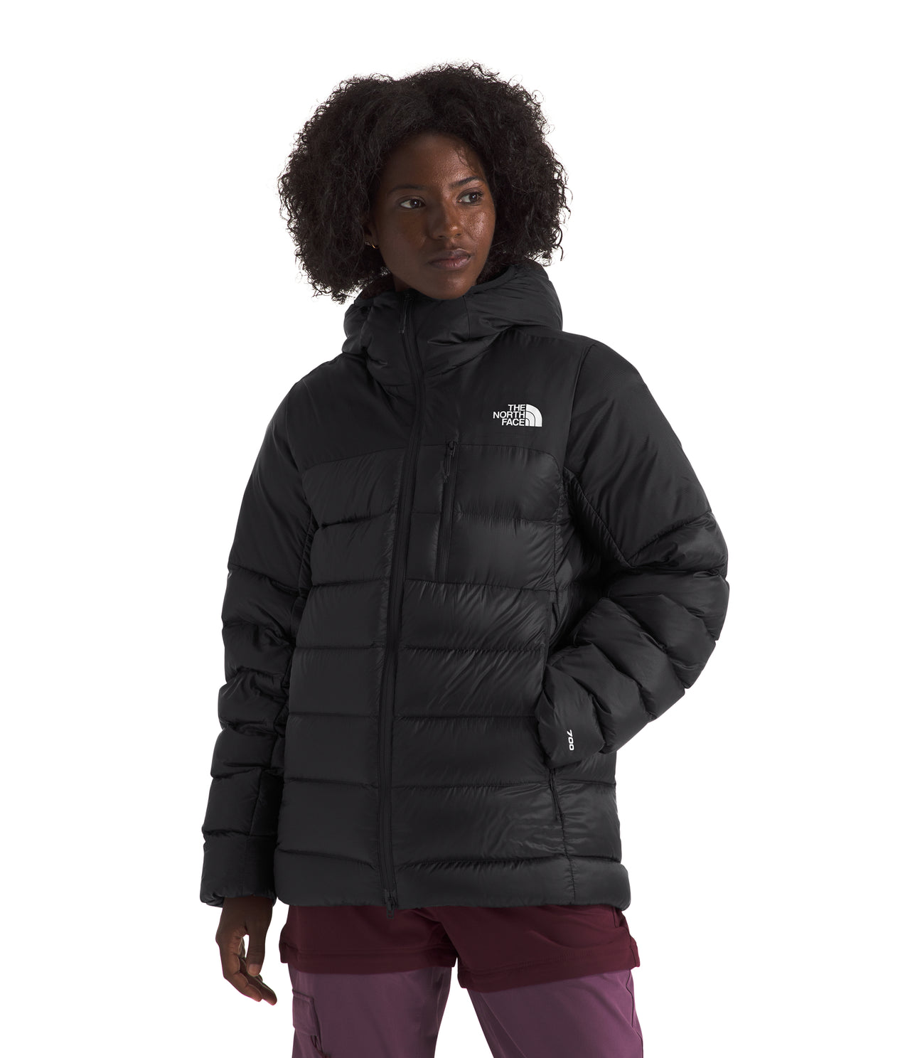 A woman wearing a black, hooded, insulated jacket.
