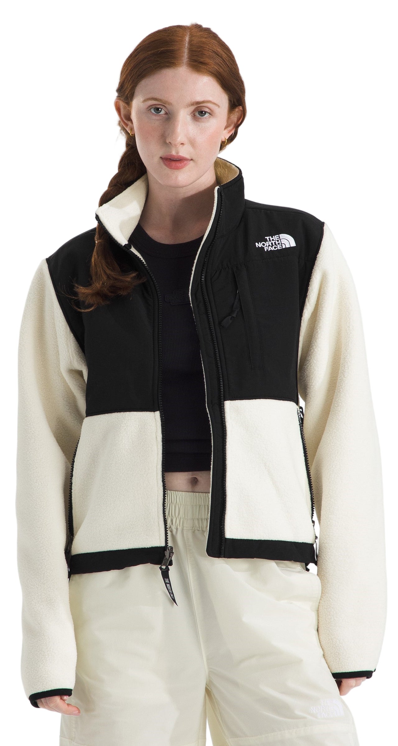 Model wearing a cream and black fleece jacket with a full zipper.