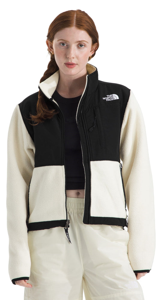 Model wearing a cream and black fleece jacket with a full zipper.