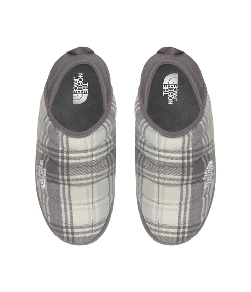 Top-down view of two gray and white plaid quilted slippers with "THE NORTH FACE" logo on the side.