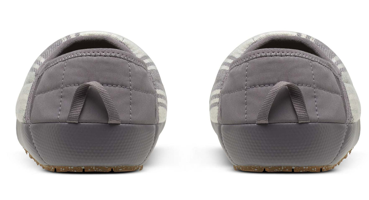 Back view of gray quilted slippers with gray pull tab and textured soles.