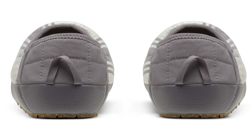 Back view of gray quilted slippers with gray pull tab and textured soles.