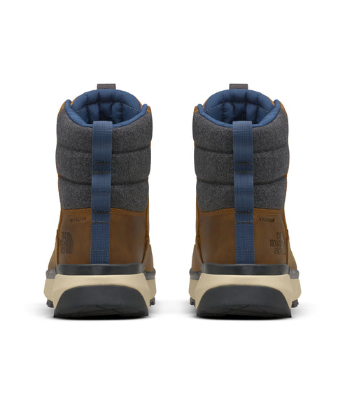 Pair of insulated brown boots with blue and grey accents viewed from the rear.