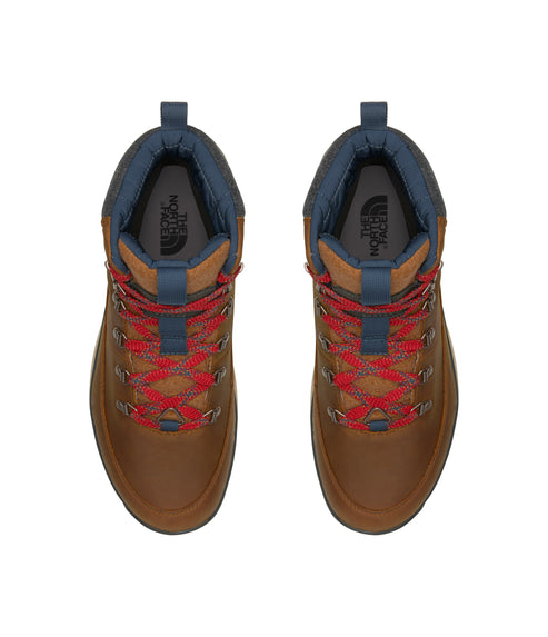 Top view of a pair of brown high top boots with red laces.
