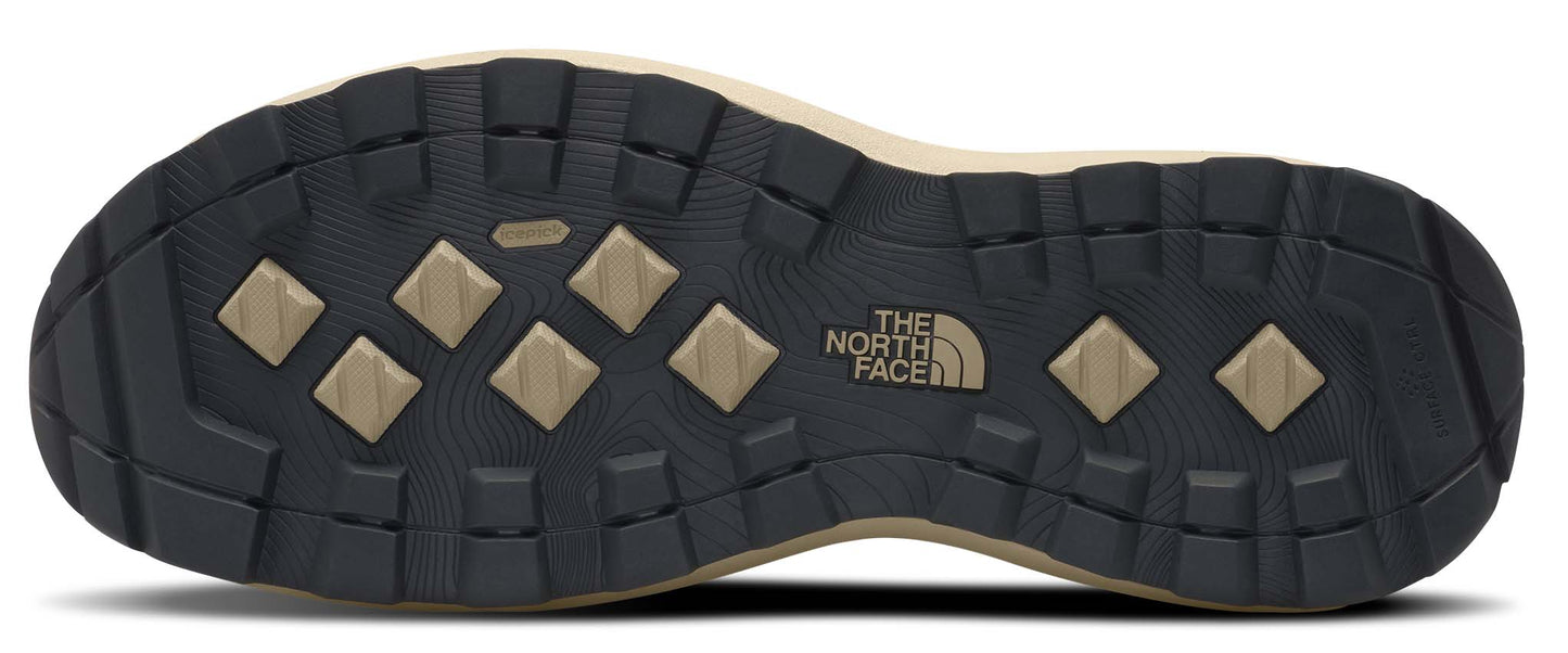 A shoe outsole with a repeating diamond pattern and a logo with the words 'THE NORTH FACE'.