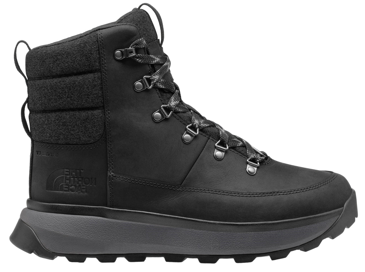 A black, high-top boot with a gray sole, padded ankle, and metal eyelets.