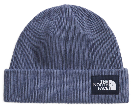 Blue knit beanie with a patch of a black square containing the words "THE NORTH FACE" in white letters and a white half-circle logo.