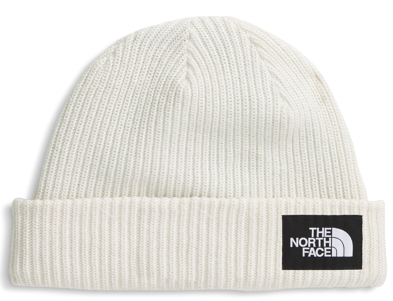 Close-fitting off-white knit hat with a black rectangular patch displaying the words 'THE NORTH FACE' stacked above a quarter circle shape.
