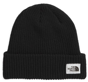 Black knit beanie with a white square label with black text on the lower right side.