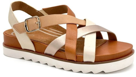 Platform sandal with crisscrossing straps in tan, brown, and ivory, featuring an adjustable buckle.