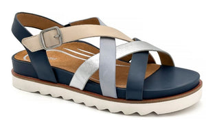 Platform sandal with navy footbed and heel strap, multi-color cross straps, and buckle.