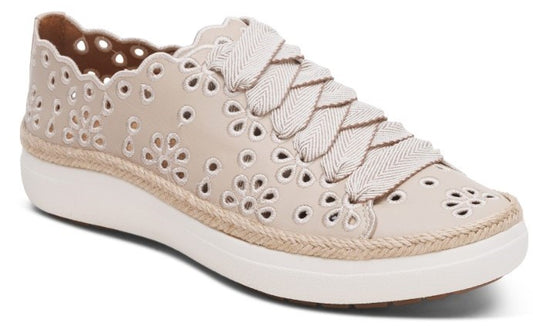 Beige sneaker with floral cutouts and wide ribbon laces.