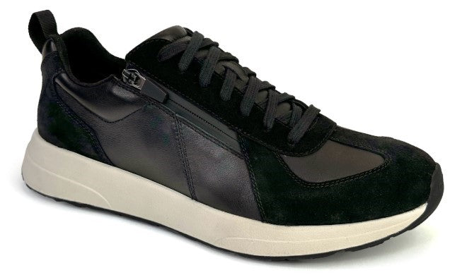 Black athletic shoe with laces and zipper on a cream colored sole.