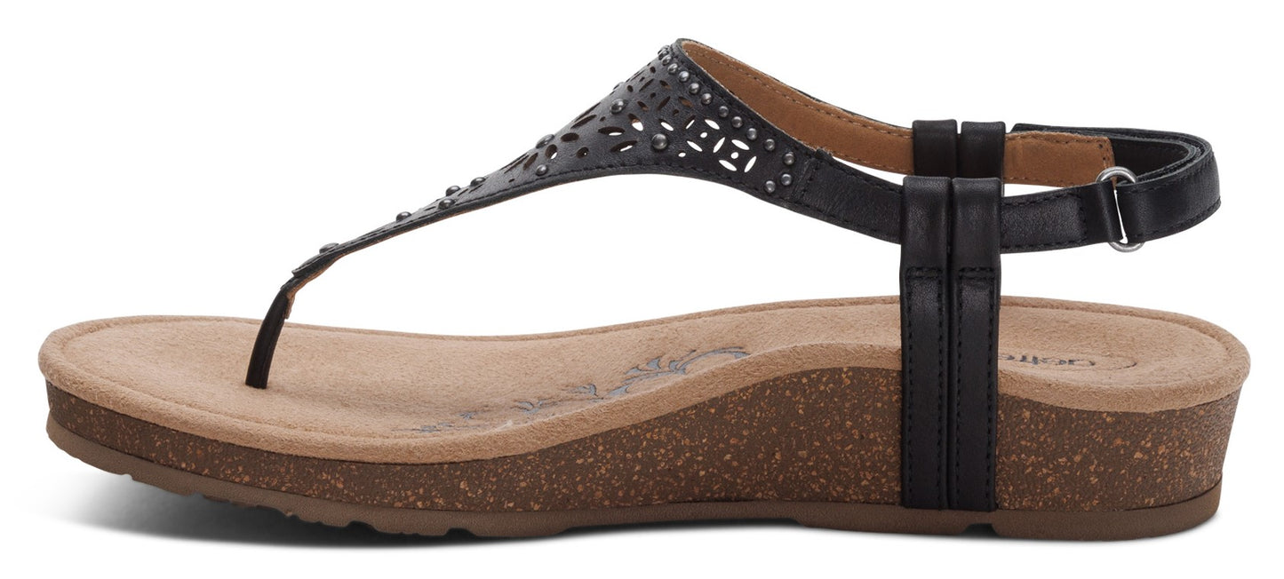 A black T-strap sandal with a tan insole and cork wedge heel.