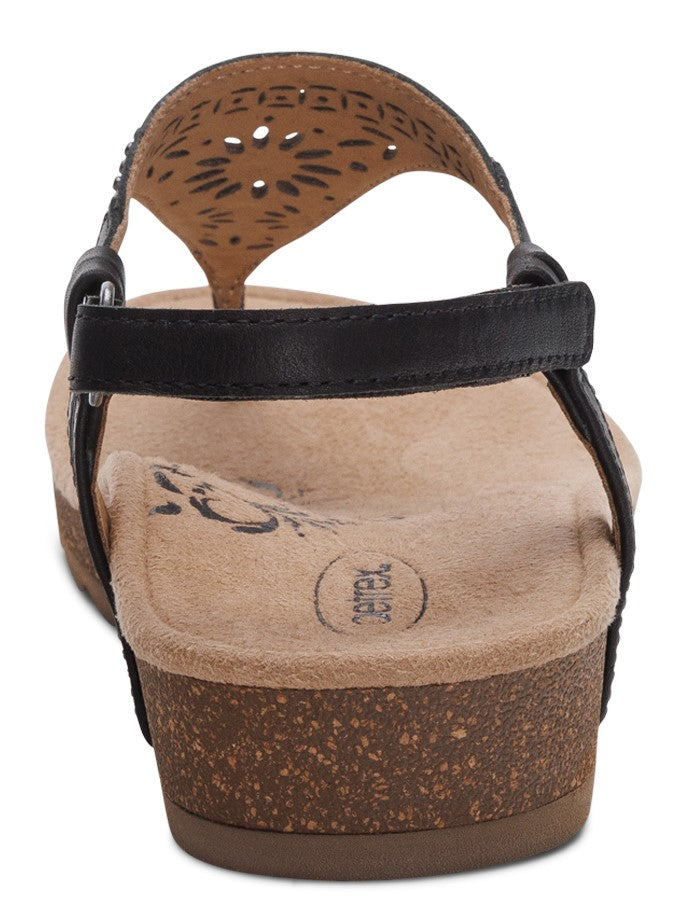 Back view of a black sandal with decorative perforations and ankle strap.