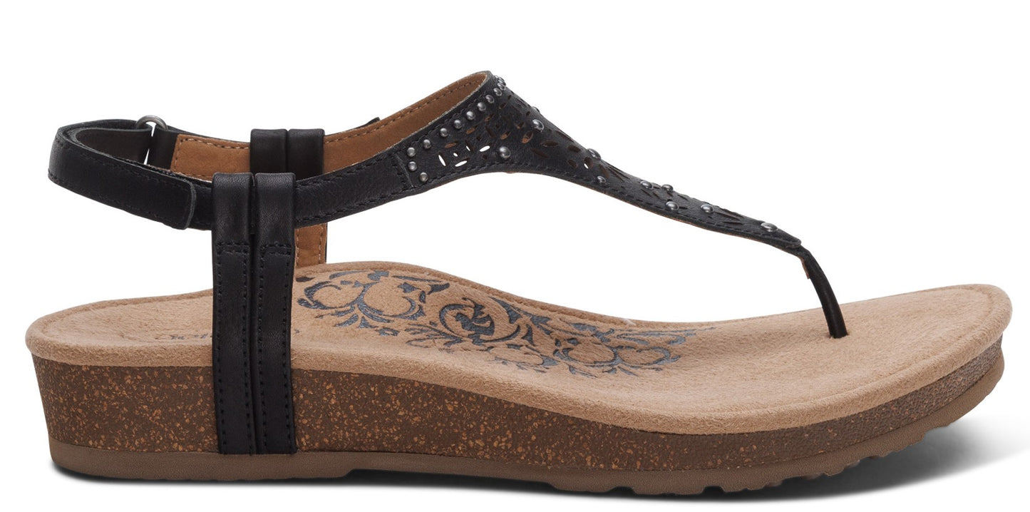 A black sandal with a toe post, ankle strap and a low wedge heel.