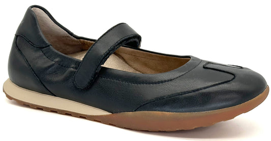 A dark navy blue leather Mary Jane flat shoe with a hook-and-loop velcro strap across the instep, featuring a tan midsole and a textured gum-colored rubber outsole.