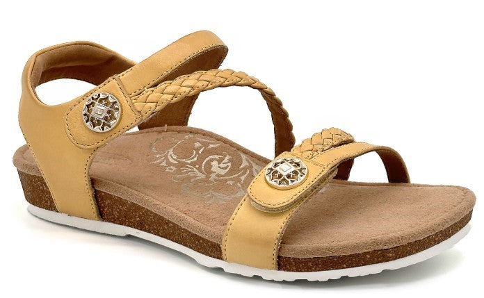 Tan sandal with adjustable straps and decorative buttons
