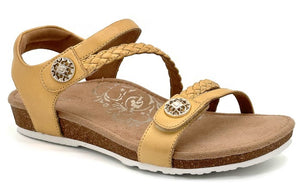 Tan sandal with adjustable straps and decorative buttons