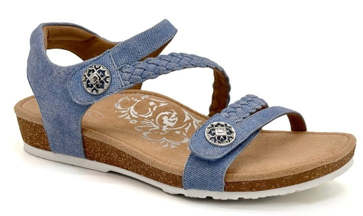 Blue denim sandal with braided straps and decorative silver buttons.