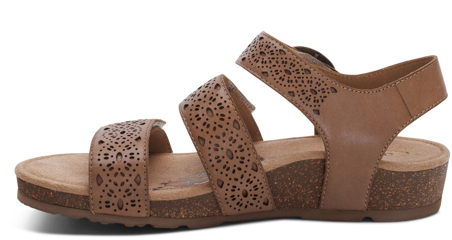 Tan sandal with three straps, decorative cutouts, adjustable heel strap and cork sole.