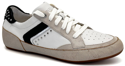 A low-top sneaker with a white leather upper, grey suede overlays at the toe and heel, a black stripe accent, silver studs on the heel and side, and white laces against a plain white background.
