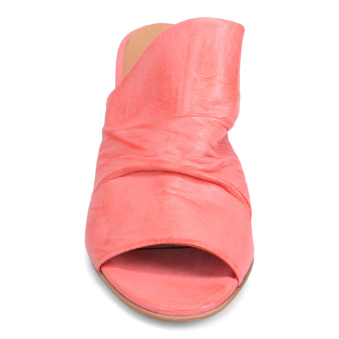 Front view of a coral-colored leather sandal with a thick heel and open toe.